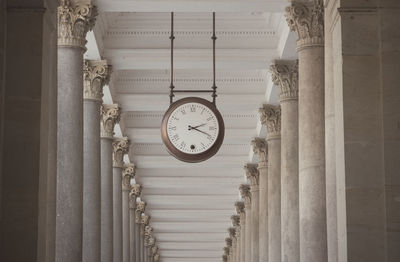 Low angle view of clock on building wall