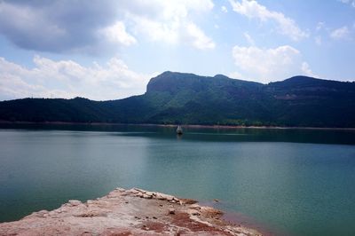 Scenic view of lake and mountains against sky