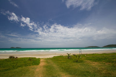 Scenic view of beach against blue sky