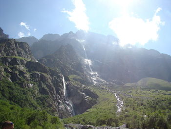 Scenic view of waterfall against sky