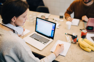 High angle view of woman using laptop on table