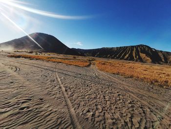 Scenic view of desert against clear blue sky