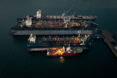 High angle view of illuminated ship moored at harbor