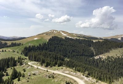 Panoramic view of road by mountains against sky