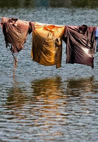 Clothes drying on rope over lake