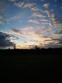 Scenic view of silhouette field against sky during sunset