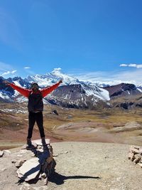 Full length of person on snowcapped mountain against sky