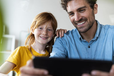 Portrait of smiling man using mobile phone