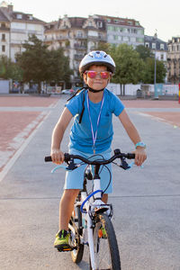 Portrait of man riding bicycle on road