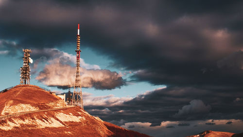 Low angle view of communications tower against sky