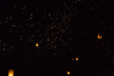 Low angle view of fireworks against sky at night