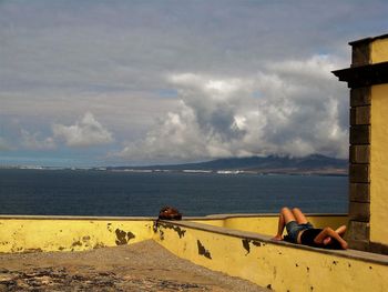 Men on beach against sky