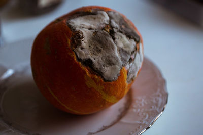 Close-up of orange slice in plate on table