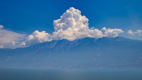 Scenic view of sea and mountains against sky