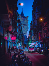 Illuminated city street at night