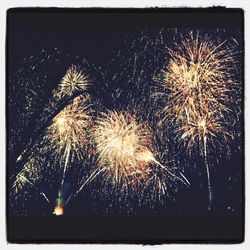 Low angle view of firework display at night