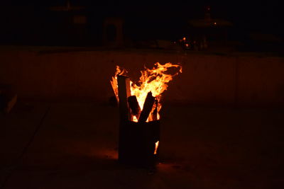 Bonfire on wooden structure at night