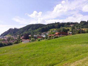 Houses on field against sky