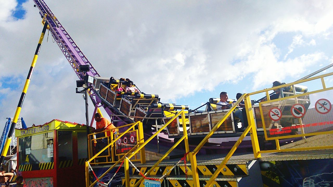 sky, low angle view, cloud - sky, built structure, architecture, cloudy, construction site, amusement park, industry, cloud, metal, building exterior, crane - construction machinery, amusement park ride, construction industry, development, metallic, outdoors, arts culture and entertainment, day