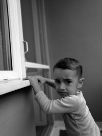 Portrait of boy standing at home