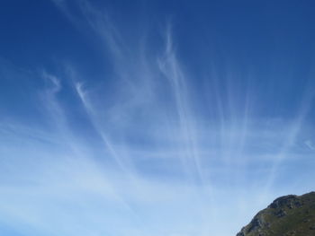 Low angle view of vapor trail in blue sky