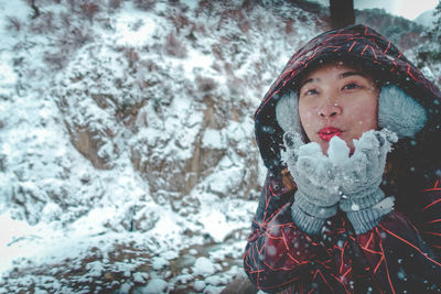 Portrait of young woman in snow