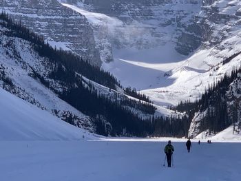 People skiing on snowcapped mountains during winter