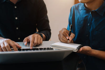 Midsection of man working at office