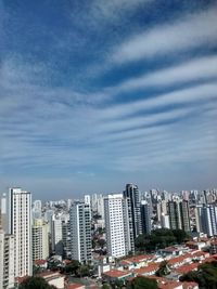 Skyscrapers against cloudy sky