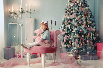 Portrait of woman sitting on sofa at home