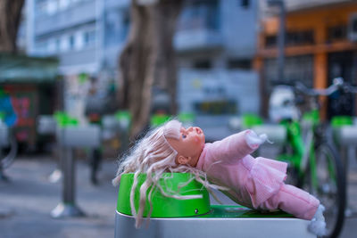 Close-up of doll in city