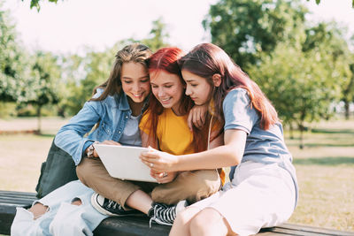 Portrait of smiling young woman using mobile phone