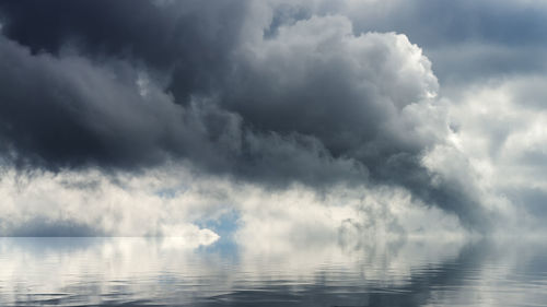 Scenic view of sea against storm clouds