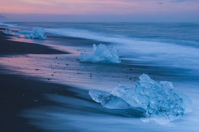 Ice lying on black volcanic beach. iceland