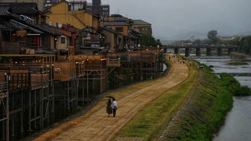 High angle view of people walking on road by buildings