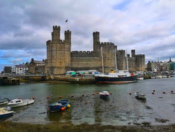 Caernarfon castle viewed across a river. caernarfon. gwynedd. wales.uk