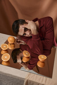 Portrait of man sitting by table