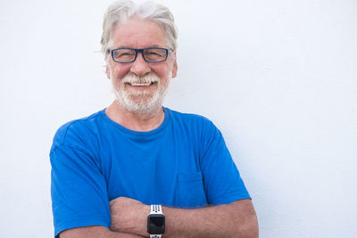 Portrait of smiling young man against wall