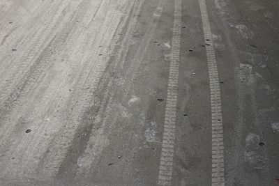 High angle view of tire tracks on street