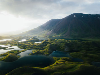 Scenic view of lake and mountains against sky