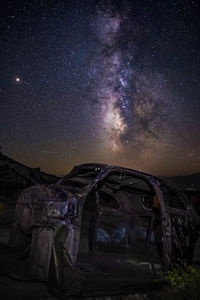 Abandoned building against star field at night