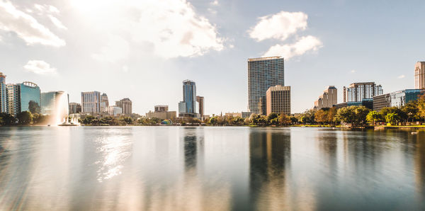 Lake against sky in city