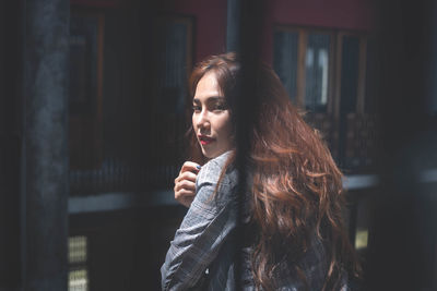 Portrait of beautiful young woman looking away