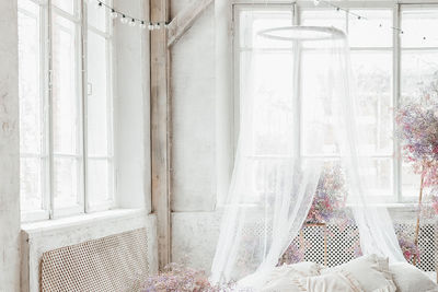 A bedroom in pastel colors in boho style.the room is decorated with pink gypsophila flowers