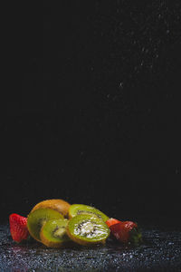 Close-up of fruits against black background
