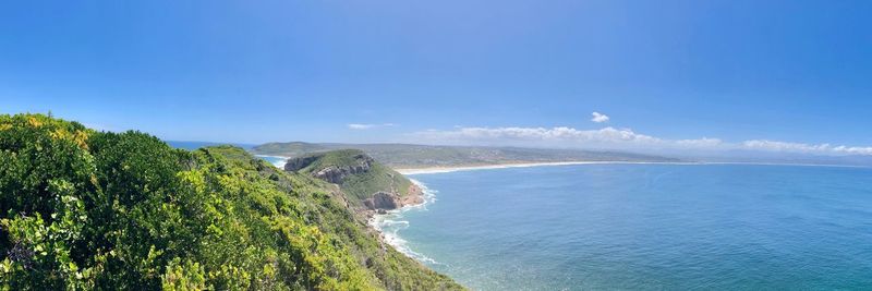 Scenic view of sea against blue sky