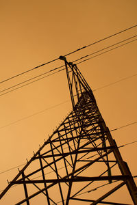 Low angle view of electricity pylon against sky