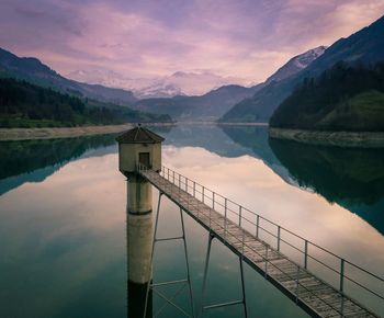 Scenic view of lake against sky at sunset