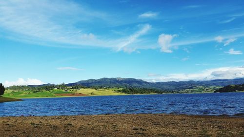 Scenic view of lake against cloudy sky