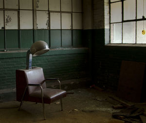 Old hair dryer chair in abandoned factory
